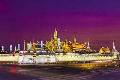 Illuminated temple against sky at night