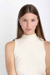 Portrait of young woman against white background