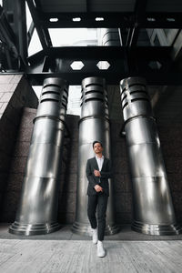 Full length portrait of young man standing at home