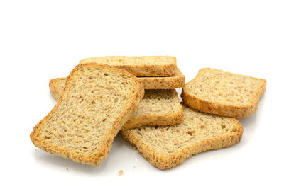 Close-up of bread in plate against white background