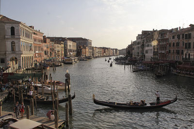 Gondola boats on grand canal amidst buildings