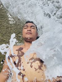 High angle portrait of young man in sea