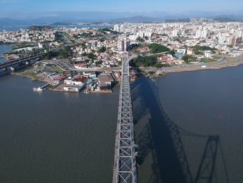 High angle view of buildings by sea against sky