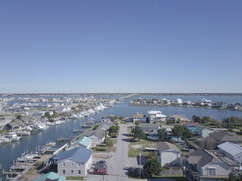 High angle view of town by sea against clear sky