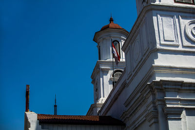 Low angle view of building against clear blue sky