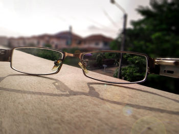 Close-up of sunglasses against sky