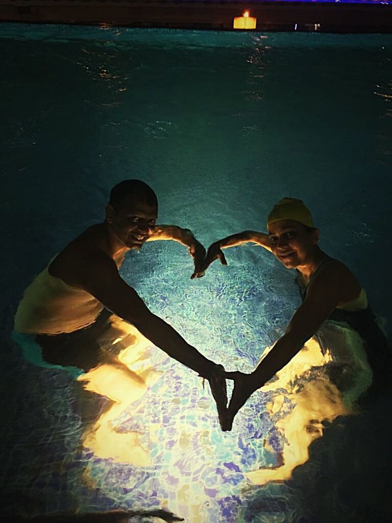 COUPLE STANDING IN HEART SHAPE