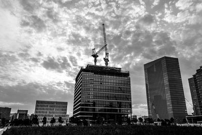 Low angle view of statue against buildings in city