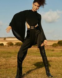 Full length of woman standing on field against sky