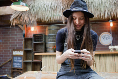 Portrait of young woman using mobile phone