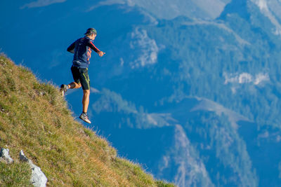 Full length of man jumping on mountain