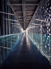 Rear view of person walking on walkway in museum