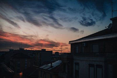 Silhouette buildings against sky during sunset