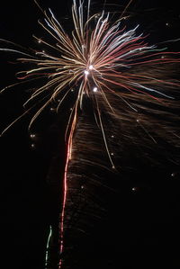 Low angle view of firework display at night