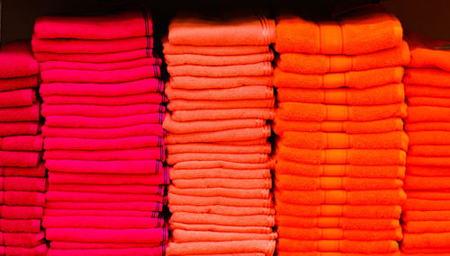 Close-up of pink and red towels for sale at market