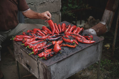 Man holding red chili peppers at market