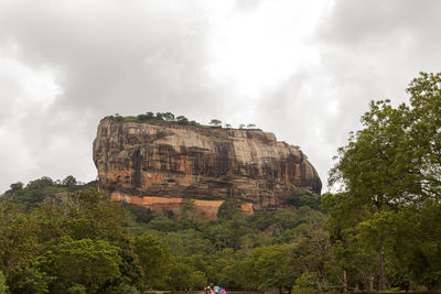 Low angle view of rock formations against sky