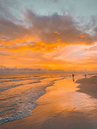 Scenic view of beach against sky during sunset