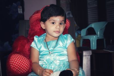 Portrait of cute girl sitting at home