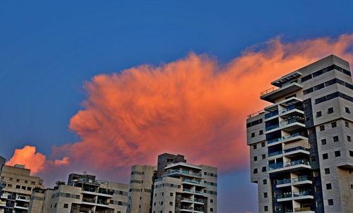 Low angle view of buildings against sky during sunset