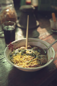Bowl with noodle soup and chopsticks