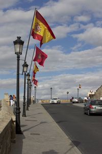 Street lights in city against sky