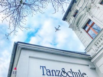 Low angle view of airplane flying against sky