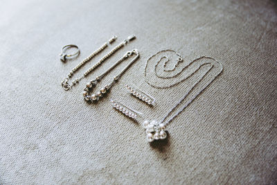 High angle view of jewelry on bed at home