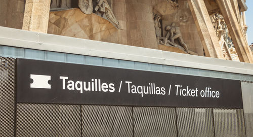 Low angle view of text on glass wall