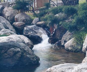 Scenic view of river flowing through rocks