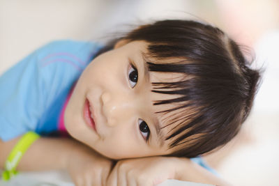 Close-up portrait of cute boy at home