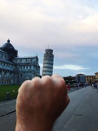 Close-up of man hand holding cityscape