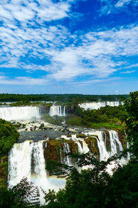 Scenic view of waterfall against sky