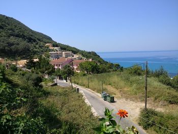Scenic view of sea and mountains against clear sky