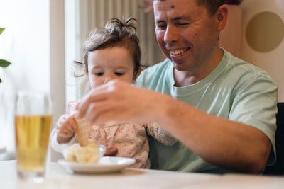 Portrait of a caucasian father with his daughter in a cafe.