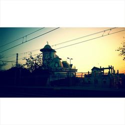 Low angle view of built structure against sky at sunset