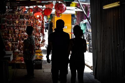 Rear view of people walking in store