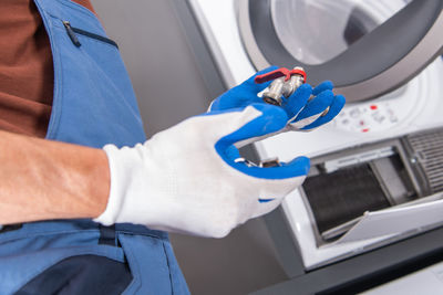 Midsection of man cleaning car