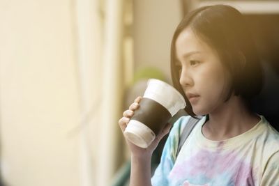 Portrait of a girl drinking from glass at home