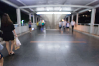 People walking in illuminated underground walkway