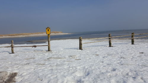 Scenic view of sea against clear sky during winter