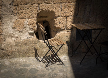 Empty chair against wall