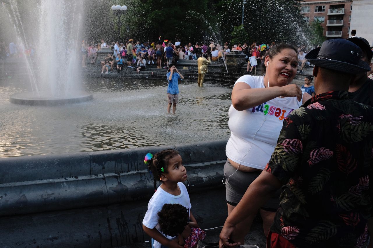 water, group of people, real people, women, childhood, child, lifestyles, girls, large group of people, architecture, enjoyment, leisure activity, females, togetherness, men, crowd, fountain, incidental people, innocence, outdoors, positive emotion, spraying, sister