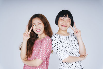 Portrait of lesbian couple against gray background