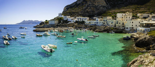 Panoramic view of sea and buildings against sky