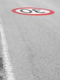 High angle view of arrow sign on road in city