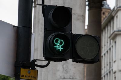 Close-up of illuminated road signal in city