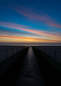 River flows into sea at sunrise