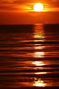 Scenic view of sea against orange sky