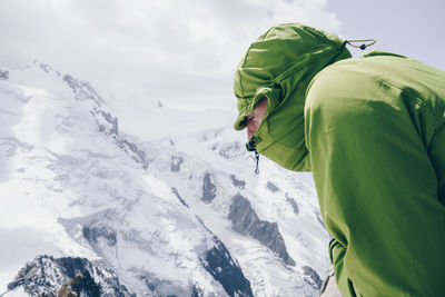 Hiker against snowcapped mountain against sky